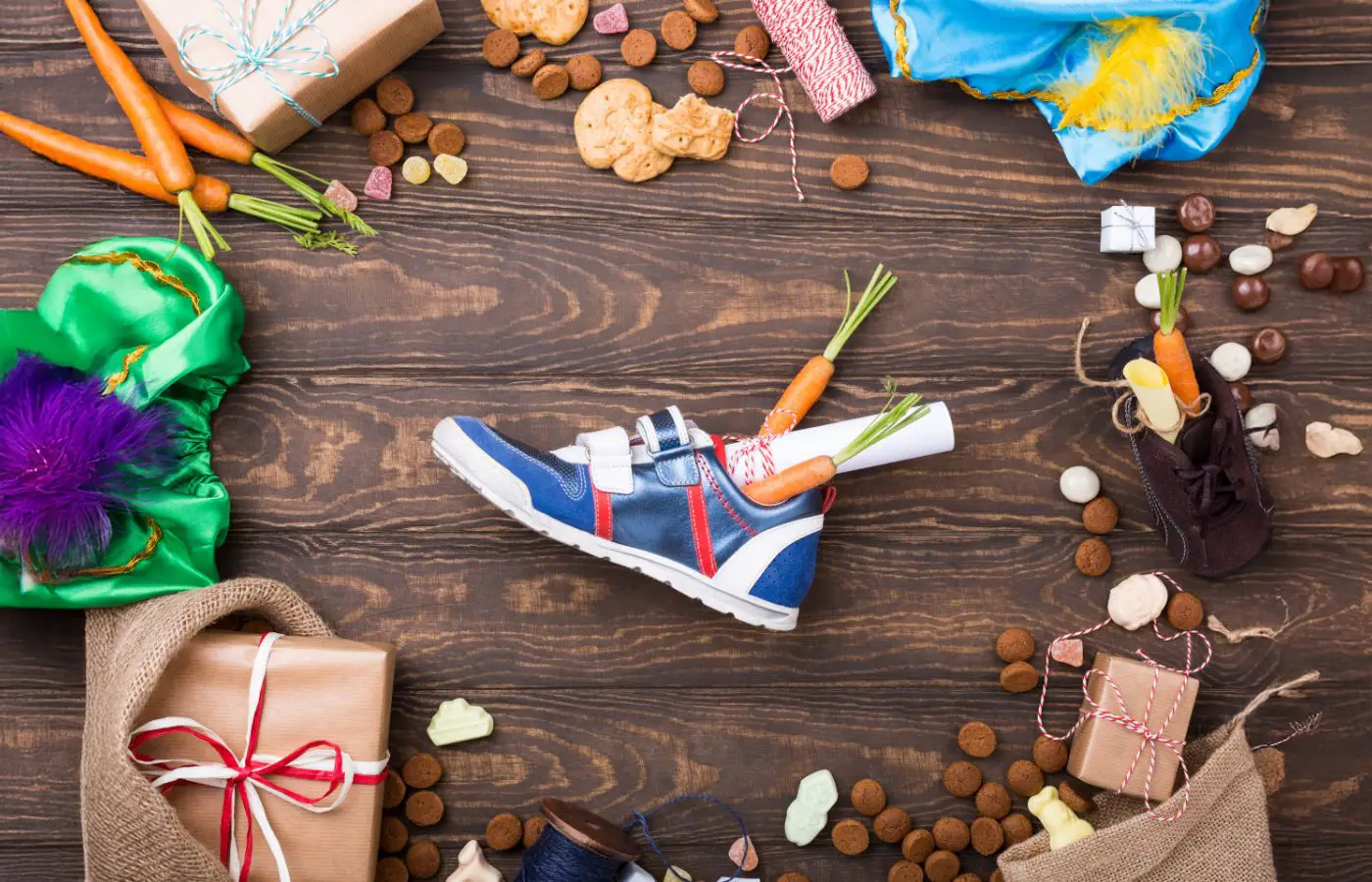 Sinterklaastraditie: schoen gevuld met wortels voor het paard van Sinterklaas, omringd door cadeautjes, snoepgoed, pepernoten en feestelijke decoraties.